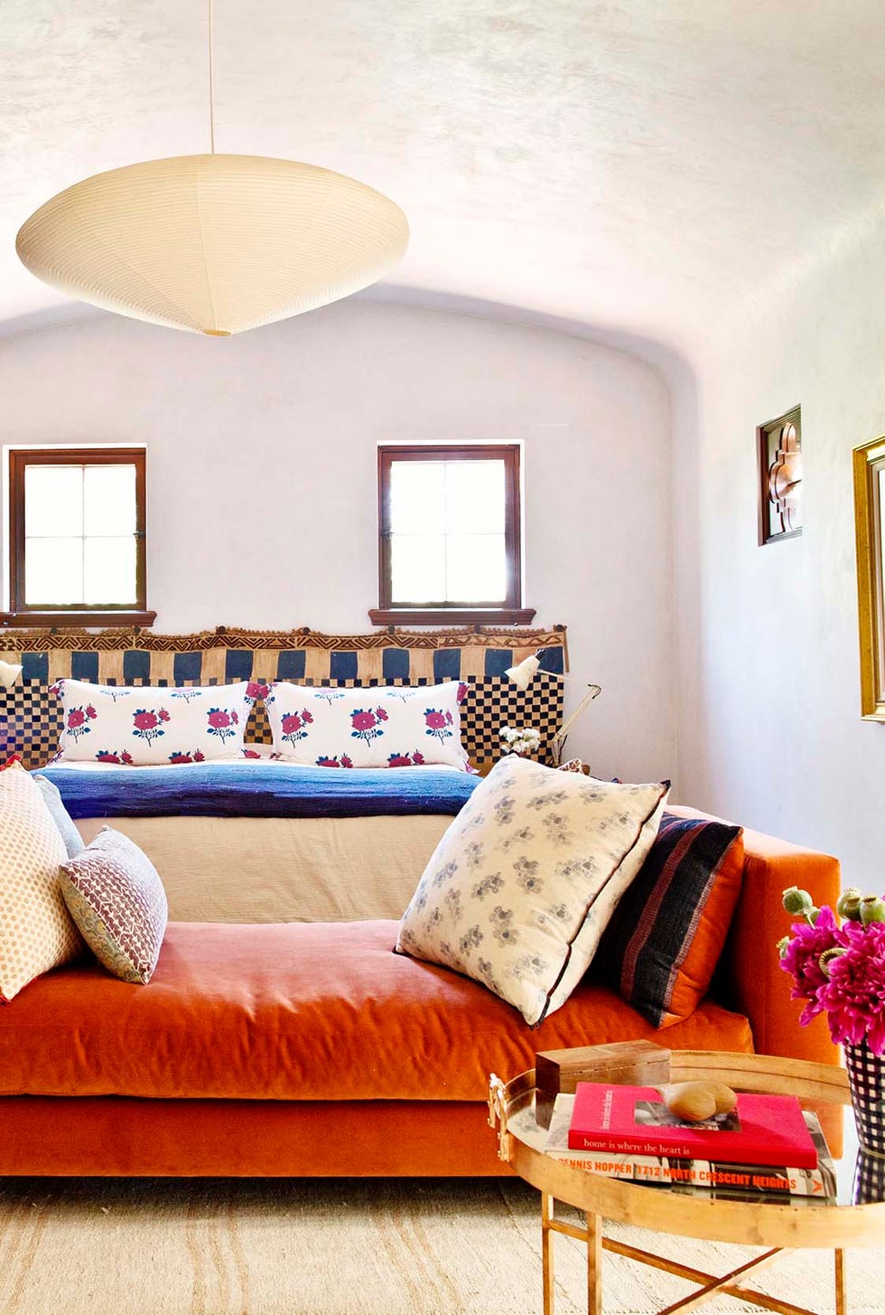 bedroom with orange end bench and tv