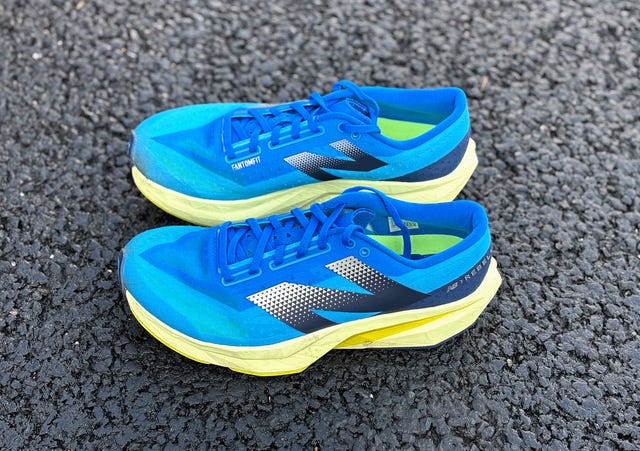 pair of blue running shoes with a yellow sole