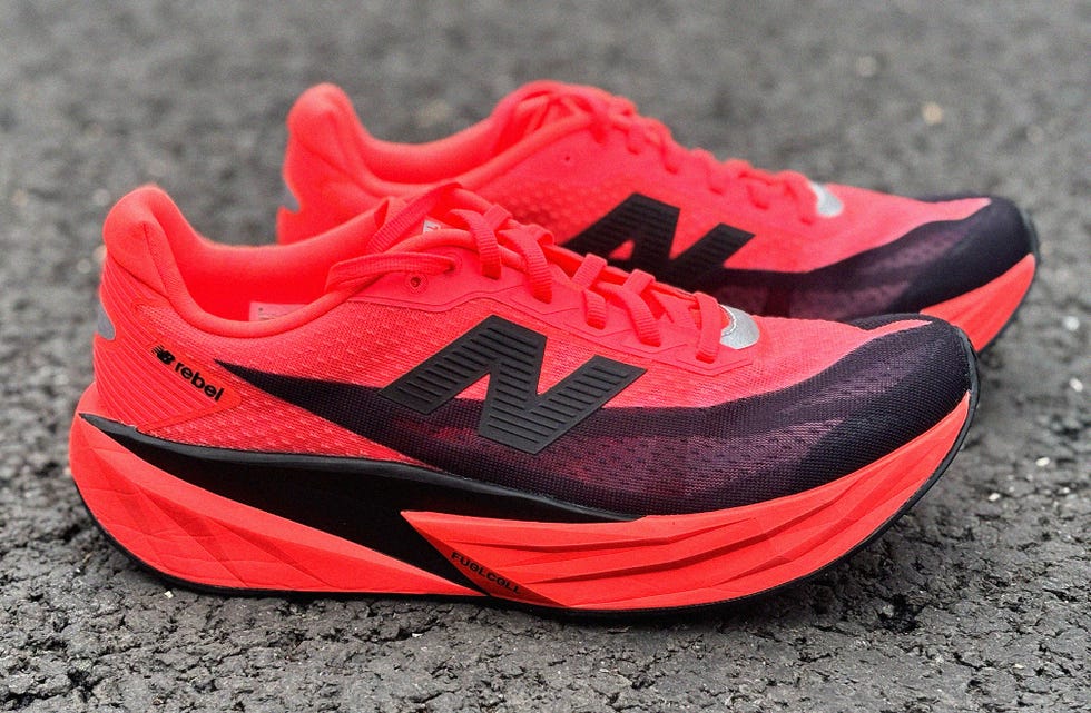 red and black new balance running shoes on pavement