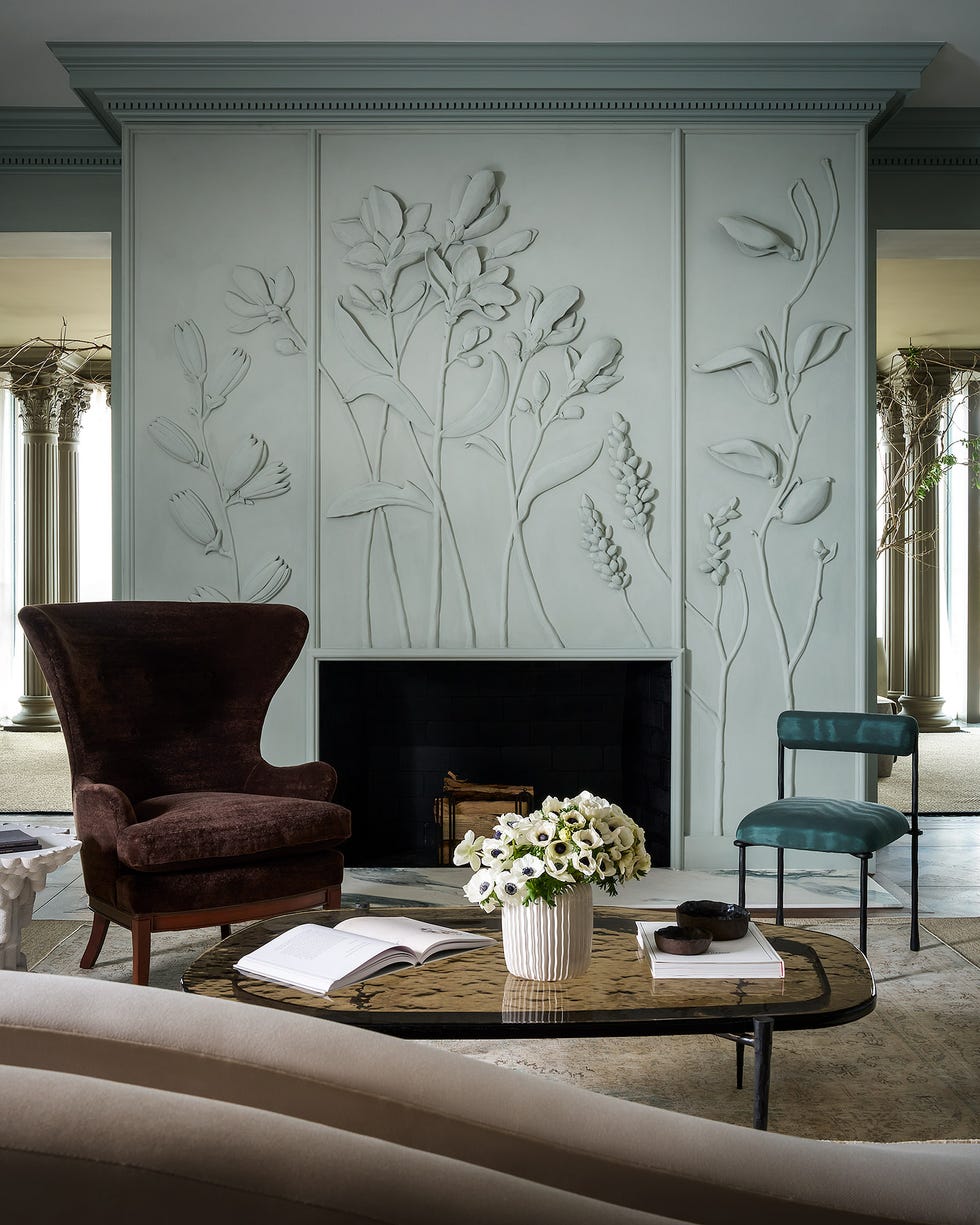 living room fireplace with plaster trees on walls