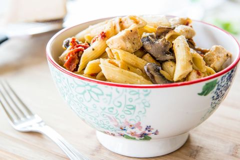 pasta with mushrooms chicken and sun dried tomatoes in bowl