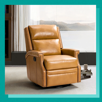 a couple of leather chairs in a room with a window
