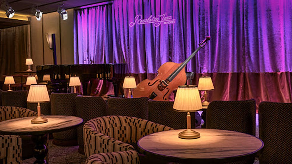 a room with a stage and chairs