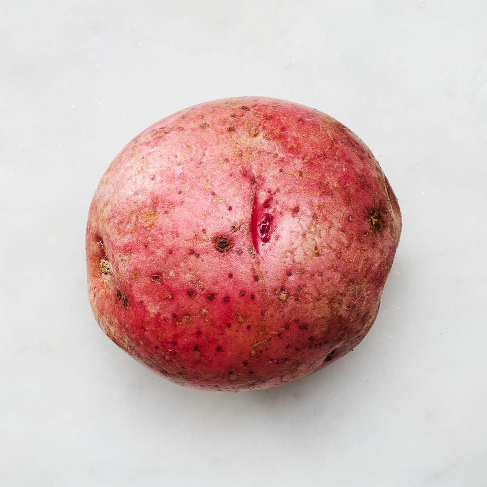 raw red potato on a light surface