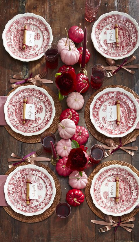 red and pink ombre painted pumpkins centerpiece with maroon flowers