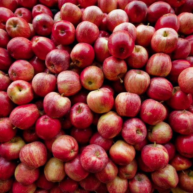 red apples lay in a pile at a fruit stand in maryland, usa