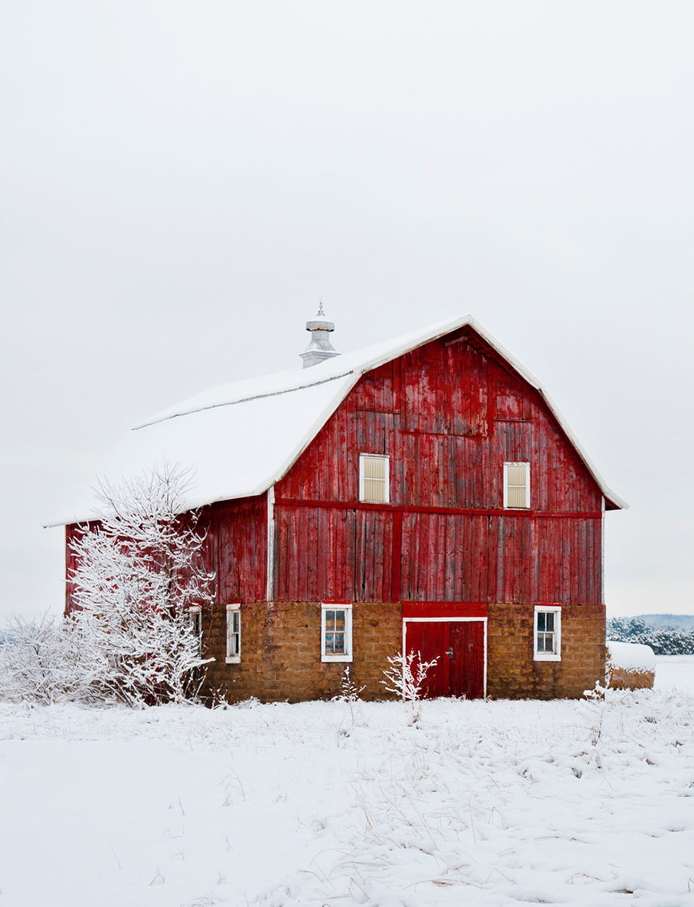 red barn covered in snow