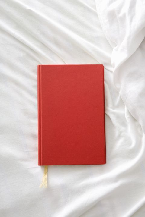 a red book on a white sheet