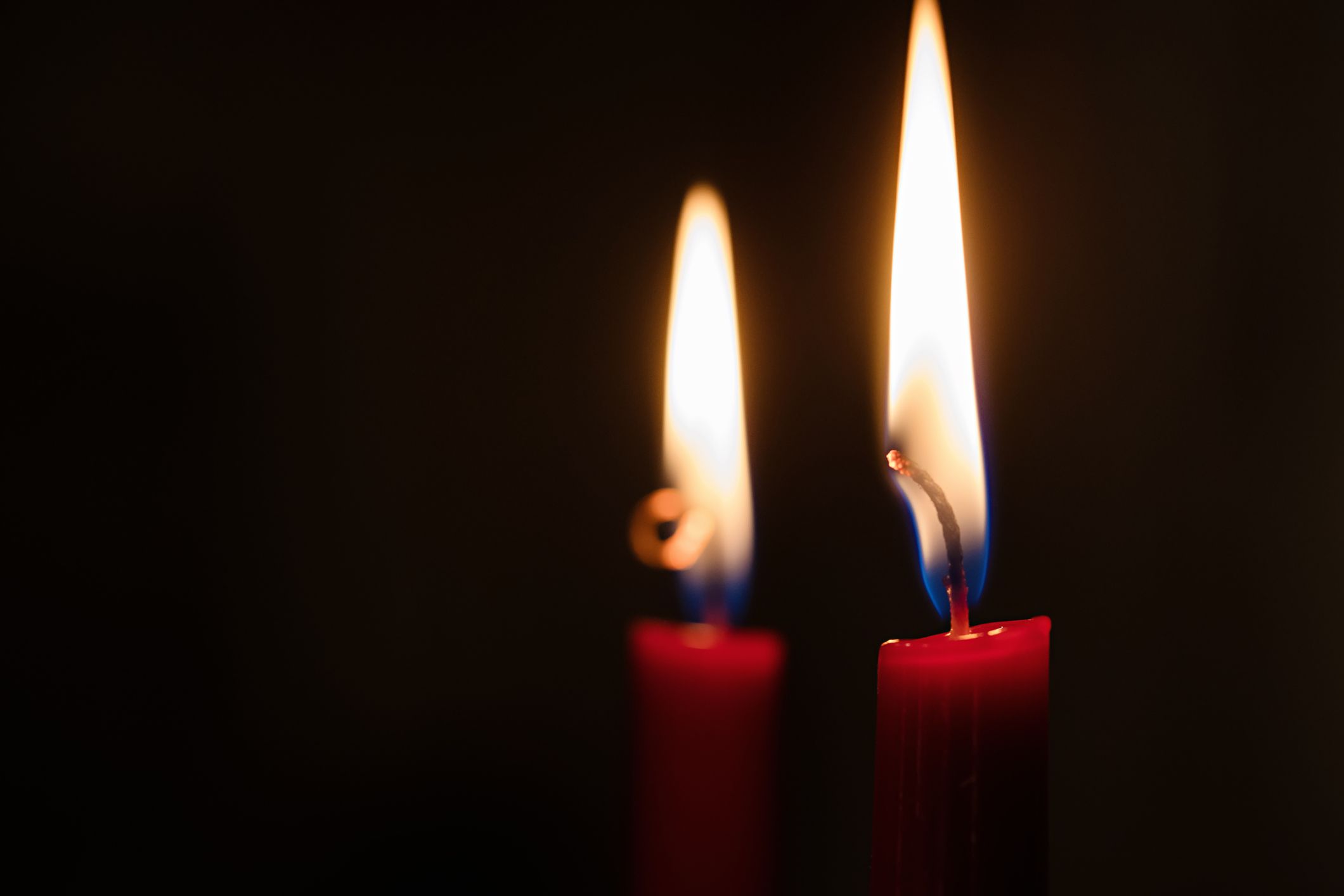 https://hips.hearstapps.com/hmg-prod/images/red-candles-aflame-royalty-free-image-1680620717.jpg