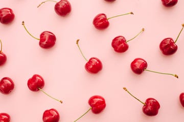 red cherry summer fruits over pink background