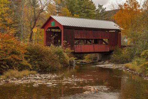 red covered bridge in vermont in autumn