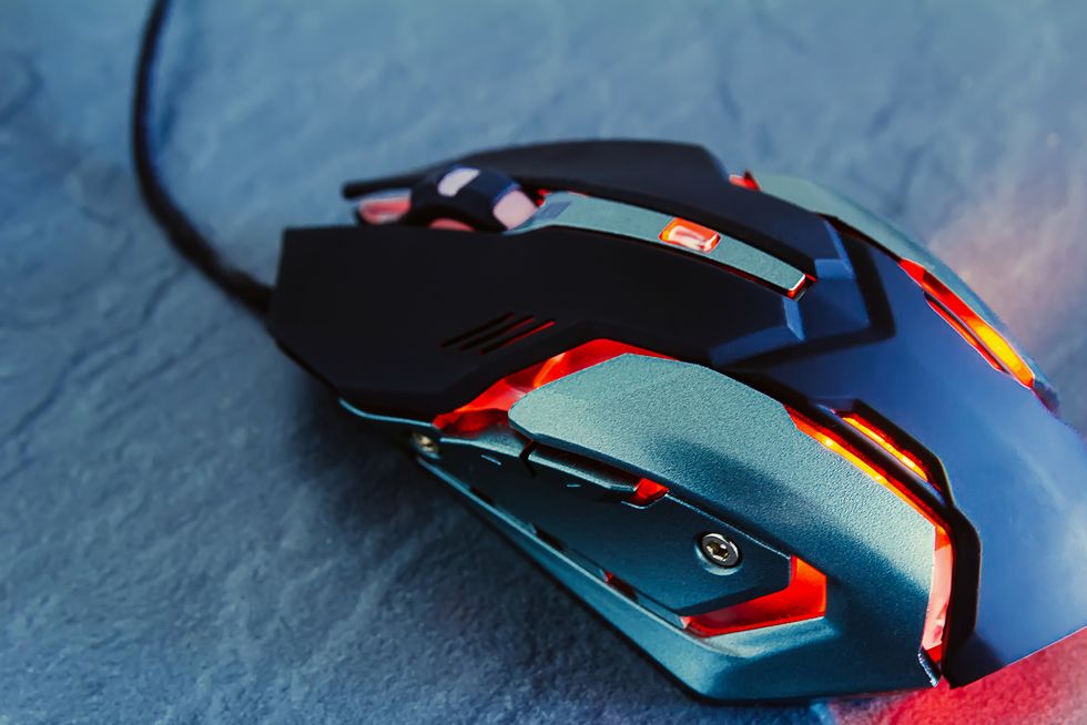 red gaming mouse on stone texture table