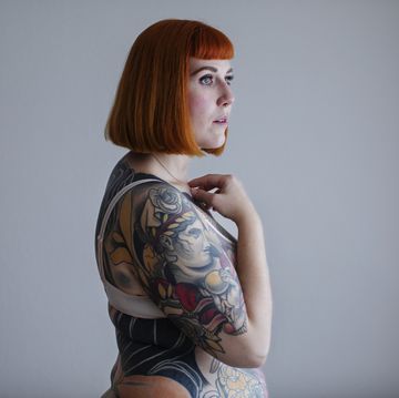 Red-haired woman with full body tattoos
