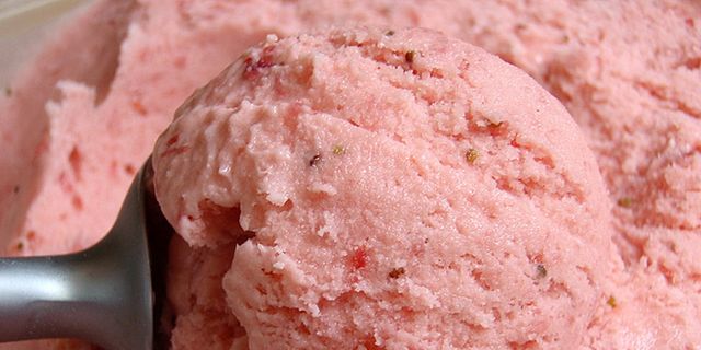 Pink strawberry and coconut ice cream scoops on plate stock photo