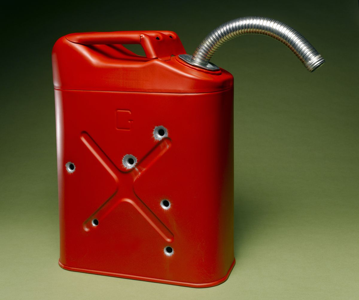 red jerry can against a green background