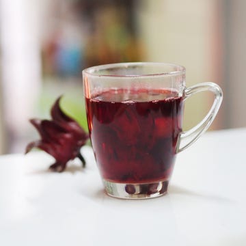 red roselle juice in clear glass on white table