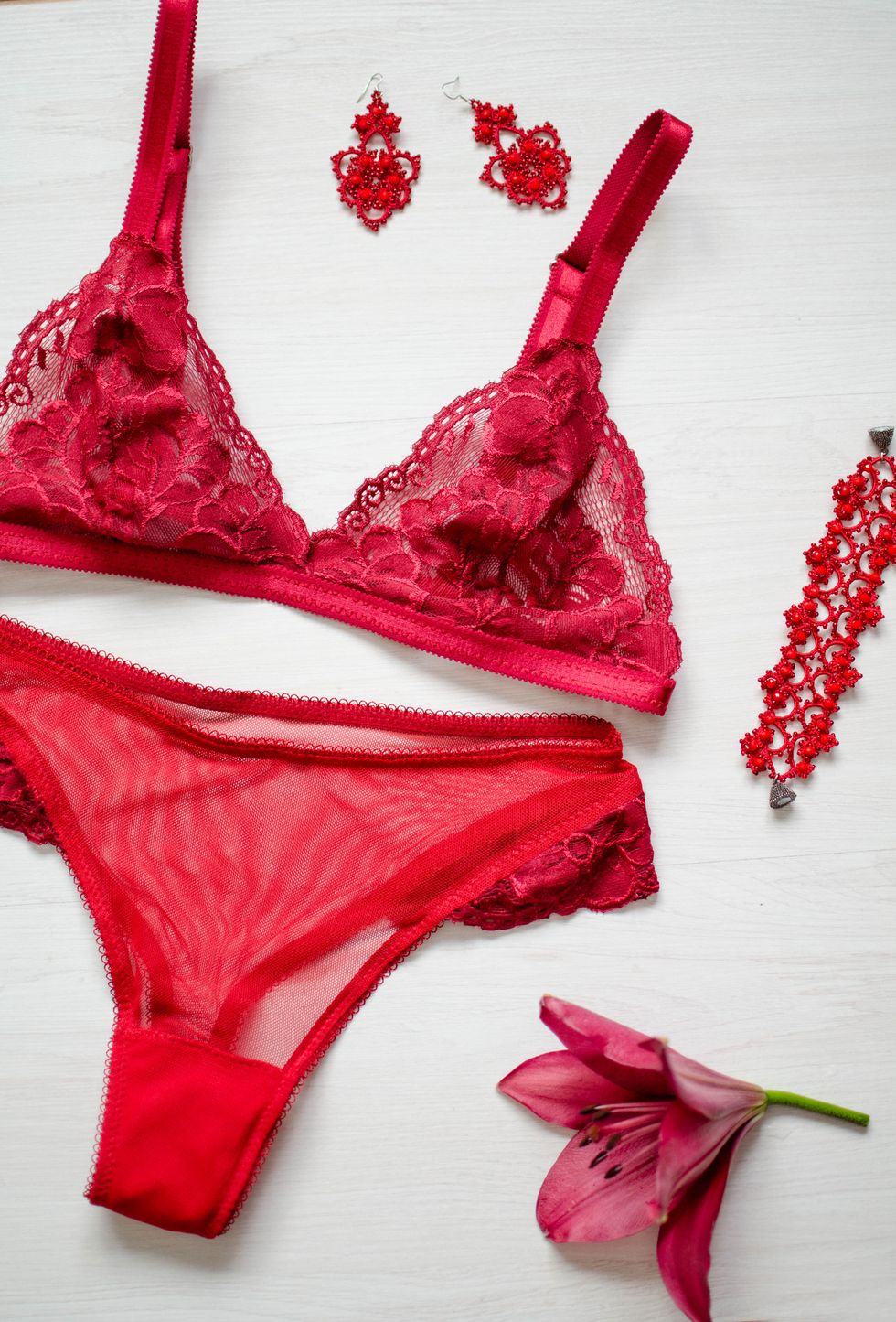 red sexy lingerie on the white background lace underwear with women's acessories and flower