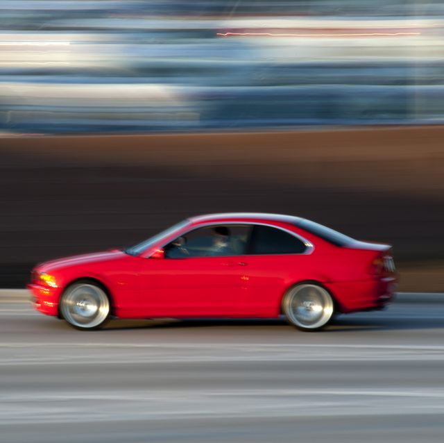 red sports sedan, blurred motion