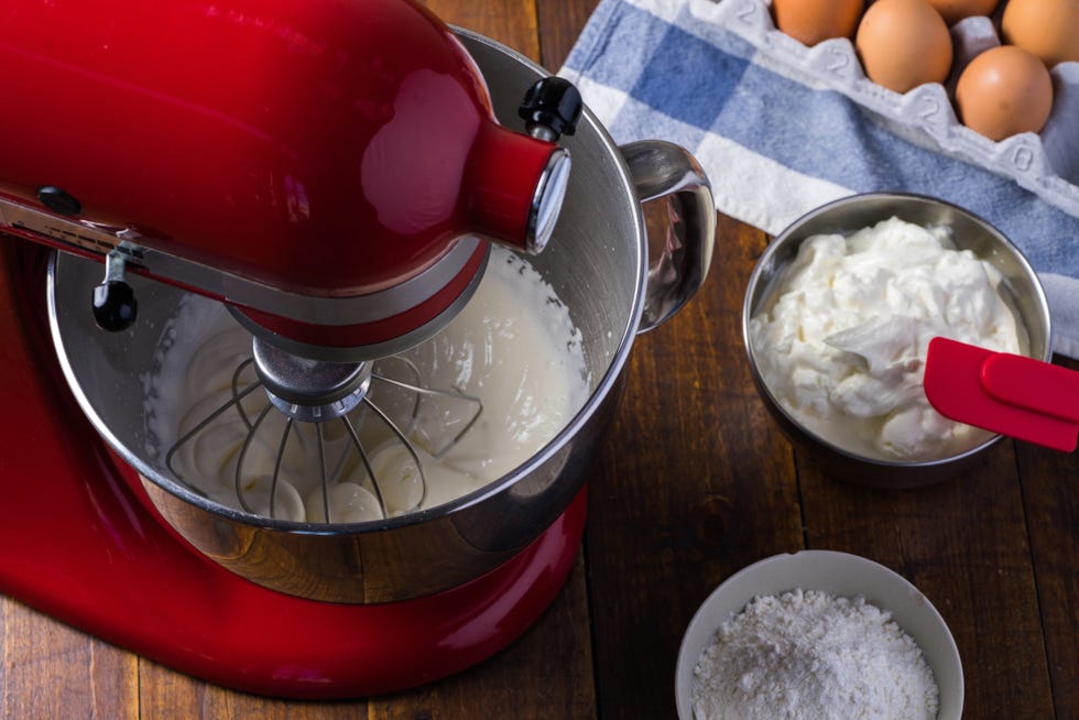 red standing mixer whipping cream