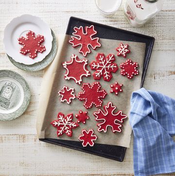 red velvet snowflakes with cream cheese icing on a tray