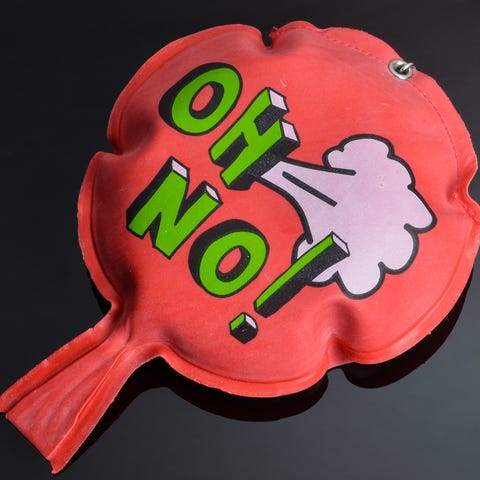 red whoopee cushion with reflection on black glass