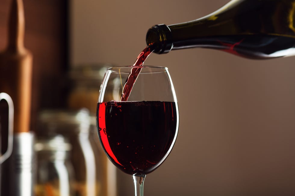 red wine being poured in a glass