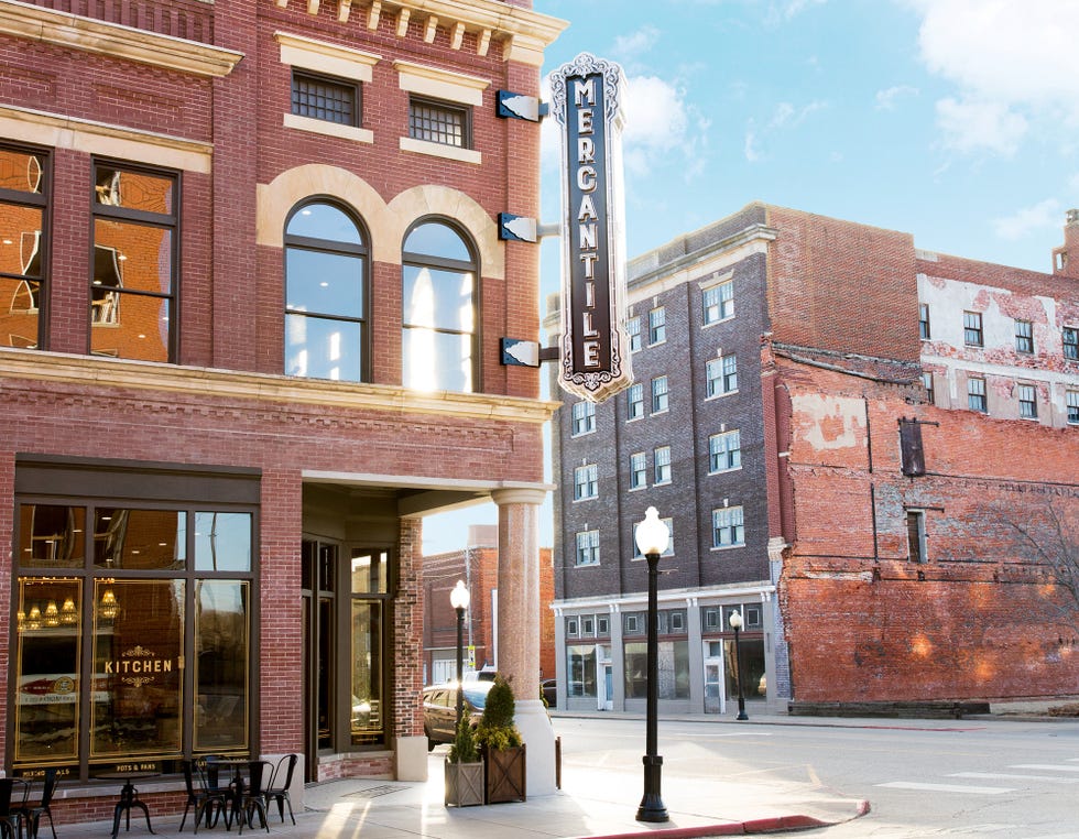 a brick building featuring large windows and a prominent sign reading mercantile