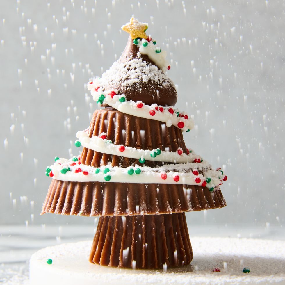 stacked reese's to make a christmas tree with icing and sprinkles