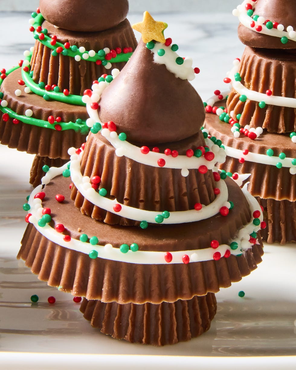 stacked reese's to make a christmas tree with icing and sprinkles