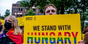 a man is holding a placard from amnesty international in support of hungary, during a demonstration against hungarys anti lgbt law, organized at the homomonument in amsterdam, netherlands on june 21st, 2021 photo by romy arroyo fernandeznurphoto via getty images