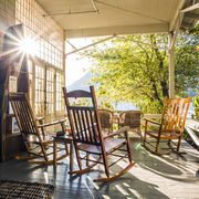 reflection of sun on porch with rocking chairs