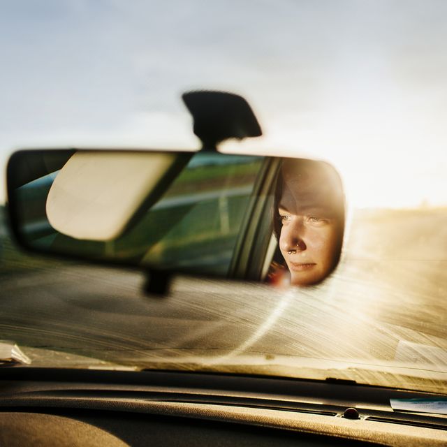reflection of woman in rear view mirror
