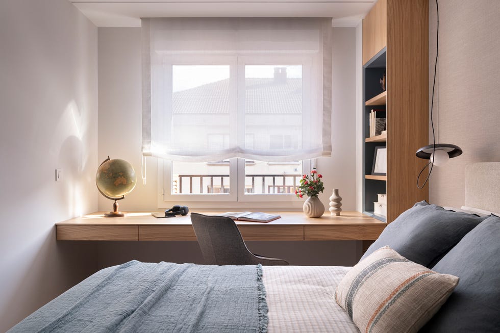 dormitorio con escritorio de madera volado y estantería