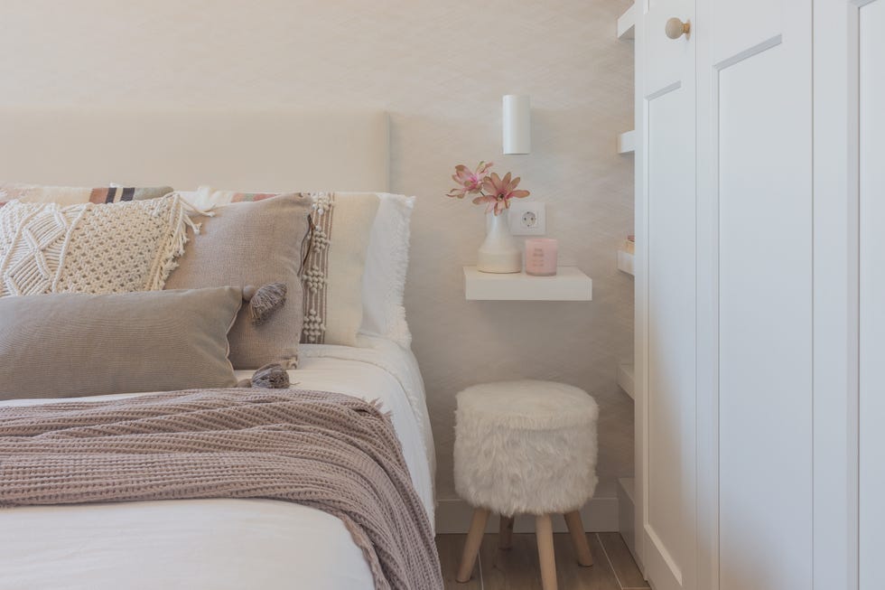 dormitorio decorado en tonos neutros con muebles blancos