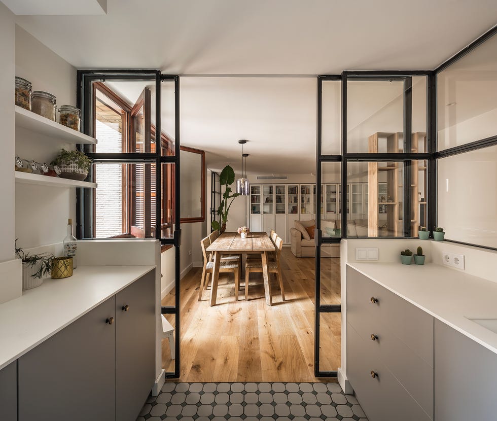 cocina abierta con cerramiento de cristal tras una reforma integral de destudio