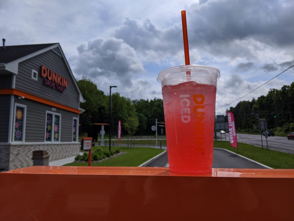 trying paige desorbo's dunkin' pink spritz refresher drink in plastic cup with straw