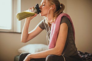 not hungry after a workout, woman drinking smoothie