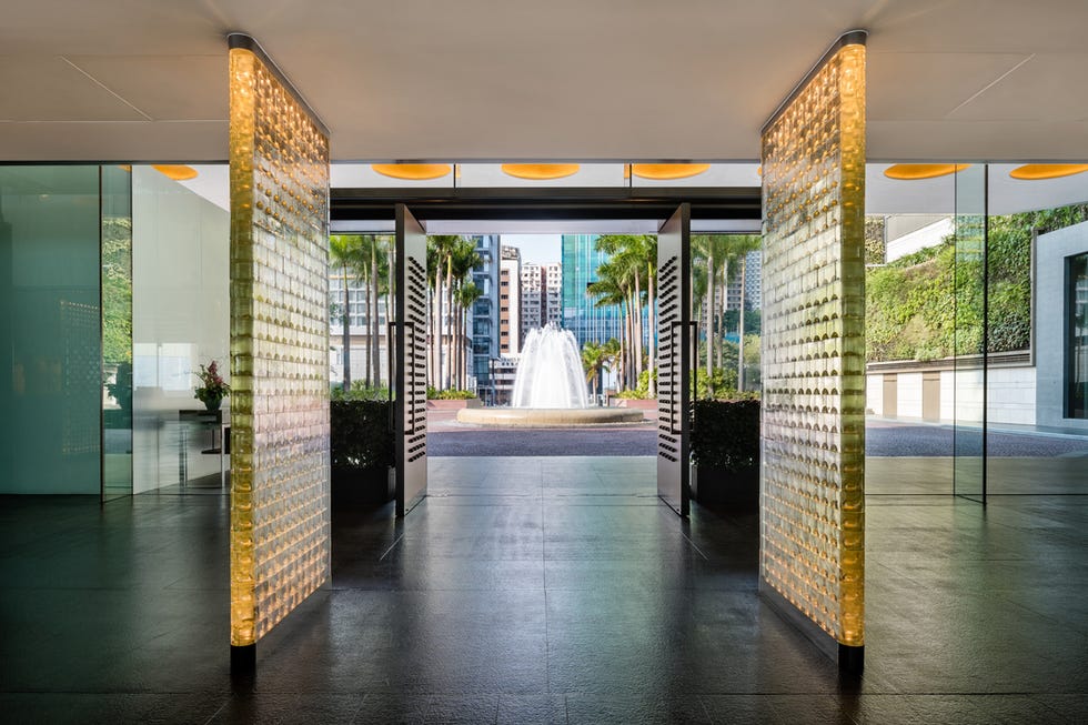 a large room with a fountain and glass doors