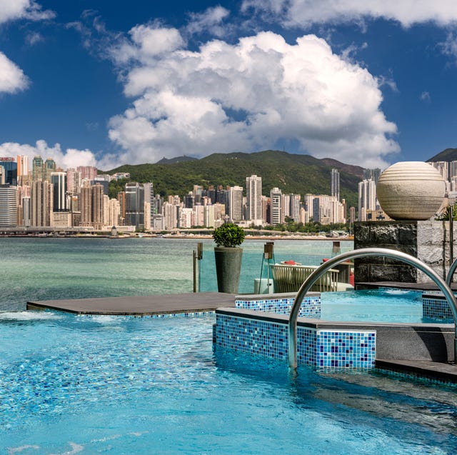 a pool with a city in the background