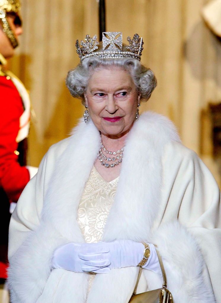 london, united kingdom   november 13  queen elizabeth ii smiling as she arrives at the palace of westminster for the state opening of parliament  the queen is wearing a diamond crown known as the state diadem made for the coronation of george lv  she is wearing an embroidered cream satin dress covered with a fur trimmed robe  photo by tim graham picture librarygetty images