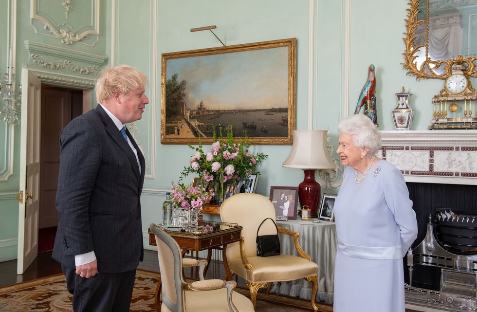 london, england   june 23 queen elizabeth ii greets prime minister boris johnson during the first in person weekly audience with the prime minister since the start of the coronavirus pandemic at buckingham palace on june 23, 2021 in london, england photo by dominic lipinski   wpa poolgetty images