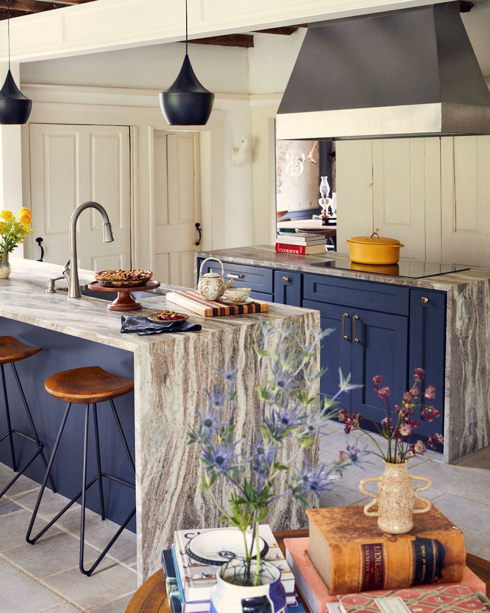 Connecticut Georgian Colonial Home Kitchen kitchen with blue cabinets and marble waterfall countertops