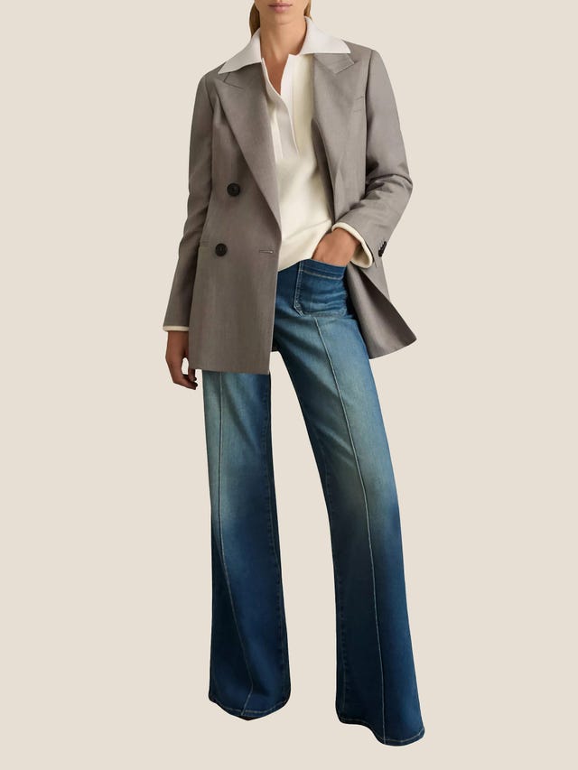 model showcasing a stylish outfit with a gray blazer and denim jeans