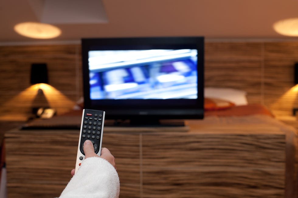 woman holding tv remote