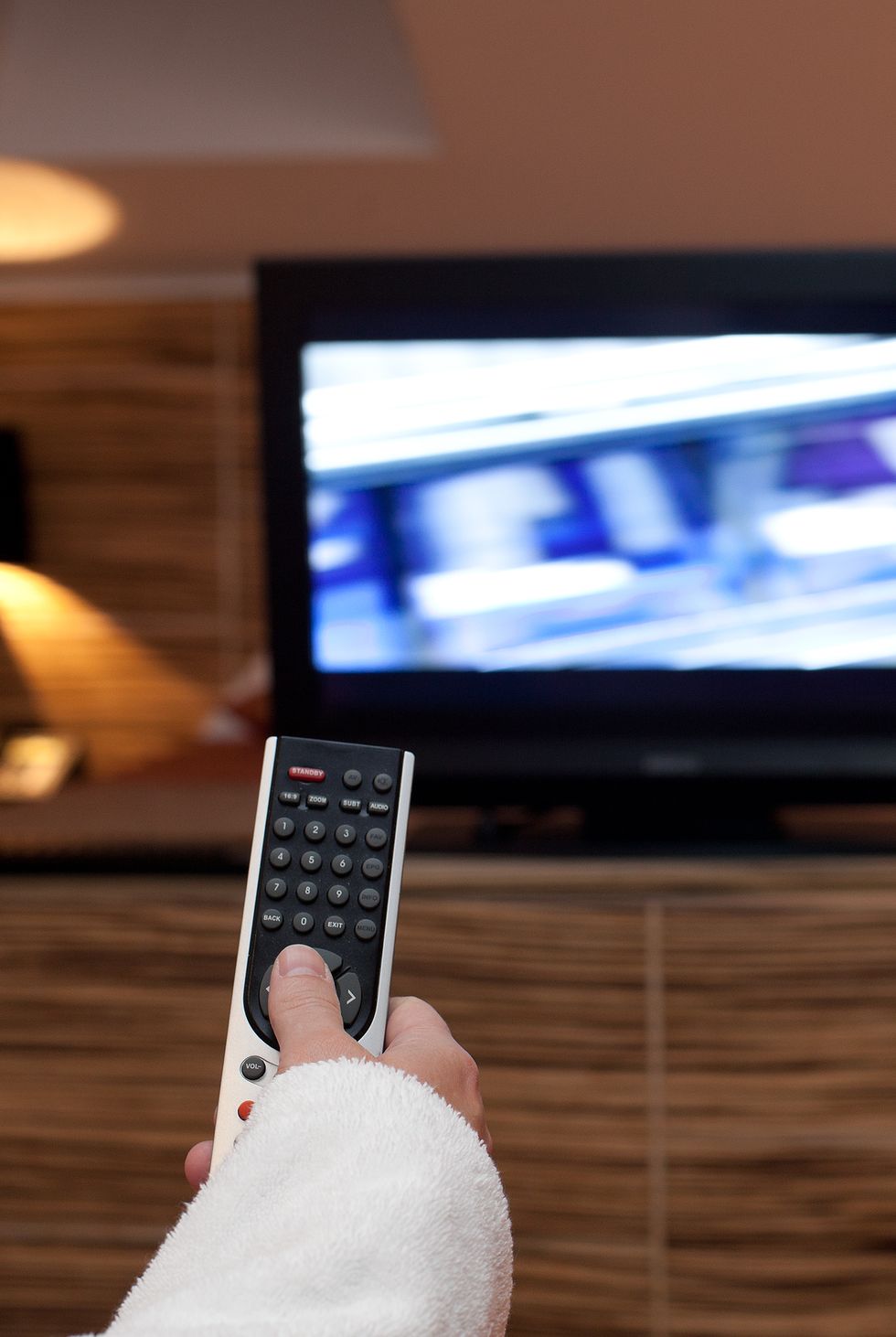 woman holding tv remote