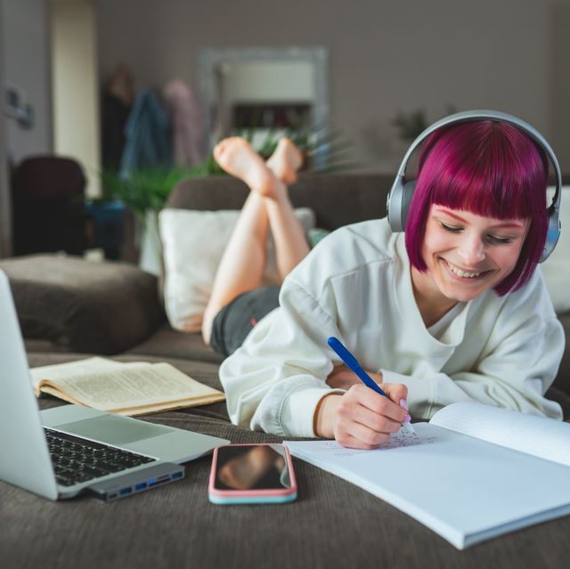 remote learning. hipster teen girl student with purple hair study at home using laptop