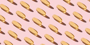 repeated fish oil pills on pink background