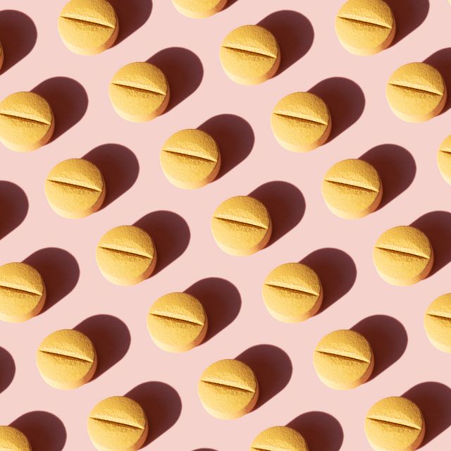 Repeated pills on pink background