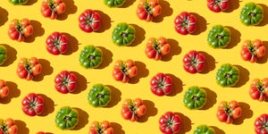 repeated red and green tomatoes on the yellwo background