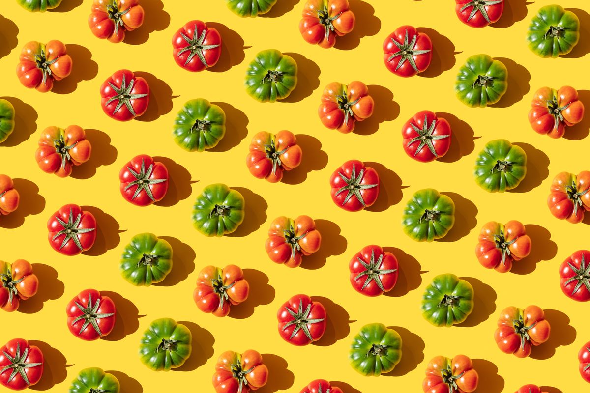 repeated red and green tomatoes on the yellwo background
